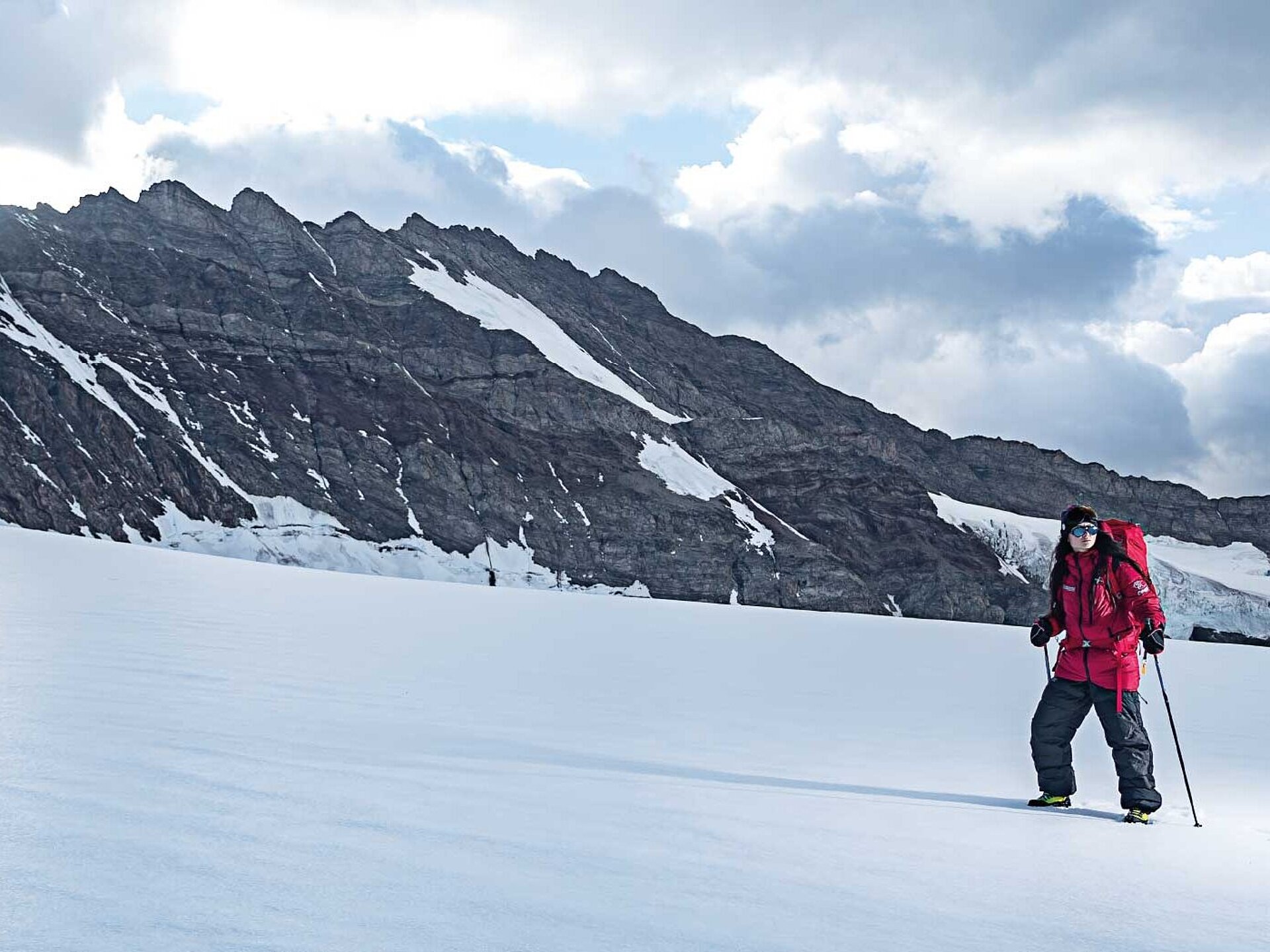 Hiker in snowy mountain landscape