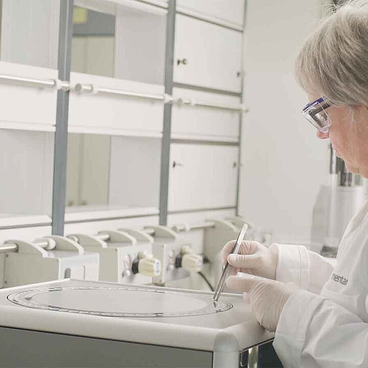 Female lab employee is placing samples on an elemental analyzer