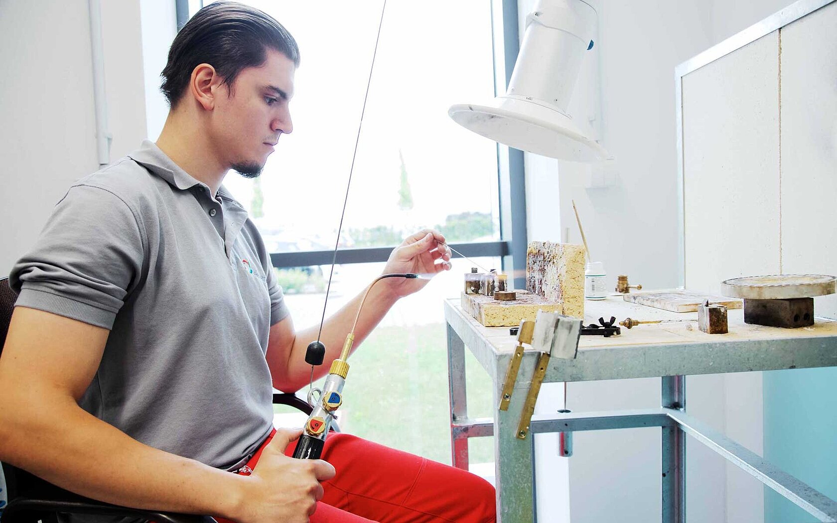 An employee doing hard soldering