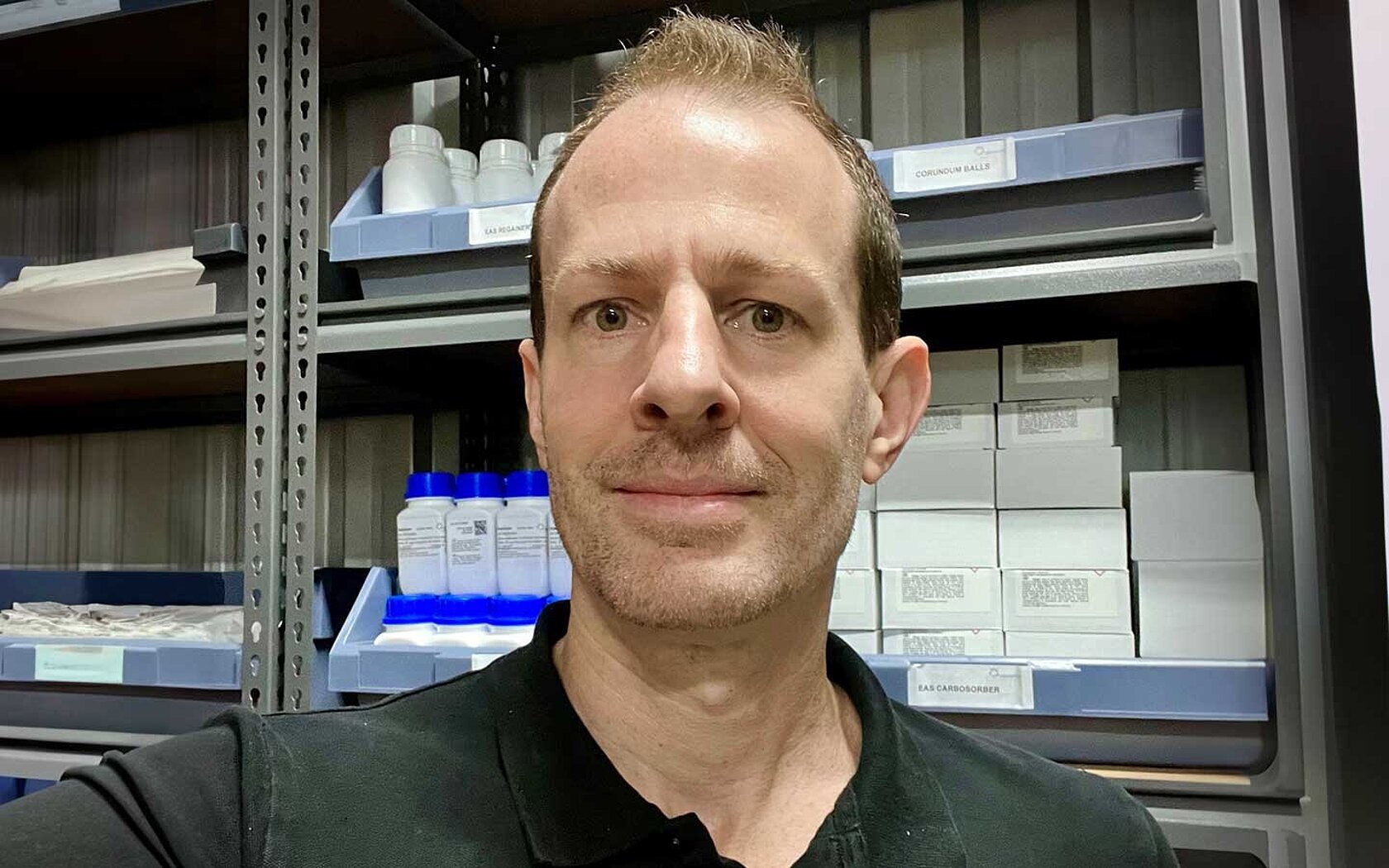 A picture of Seth Bremner in front of a storage room
